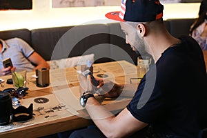 Male friends in cafe talk discuss with technology phone tablet