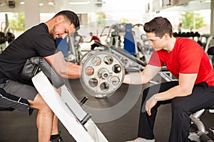 Male friends working out at the gym