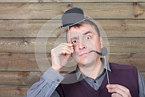 Male with funny hat and smoking pipe on a sticks