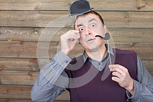 Male with funny hat and smoking pipe on a sticks