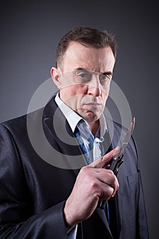 Male gangster in a business suit with a knife