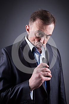 Male gangster in a business suit with a knife