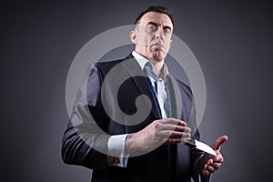 Male gangster in a business suit with a knife