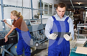 Male glazier working in glass factory