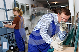 Male glazier working in glass factory