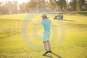 male golf player on professional sunny course with green grass, hobby