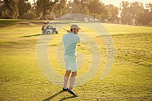 male golf player on professional sunny course with green grass, hobby