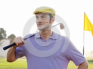 Male Golfer Holding Club On Golf Course