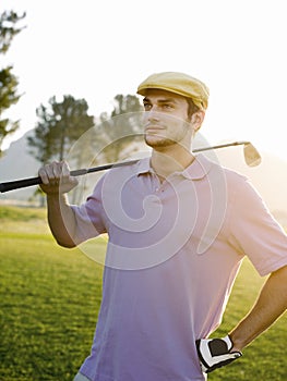 Male Golfer Holding Club On Golf Course
