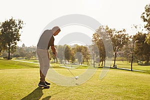 Male Golfer Lining Up Tee Shot On Golf Course