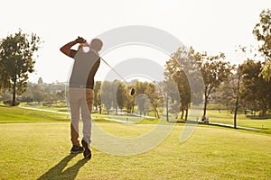 Male Golfer Lining Up Tee Shot On Golf Course