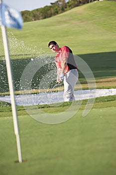 Male Golfer Playing Bunker Shot