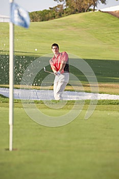 Male Golfer Playing Bunker Shot