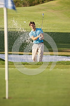 Male Golfer Playing Bunker Shot