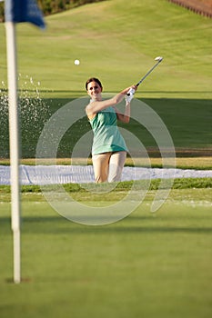 Male Golfer Playing Bunker Shot