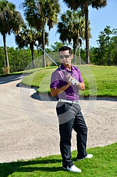 Male Golfer Poses With Golf Club