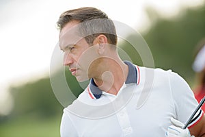 Male golfer posing outdoors