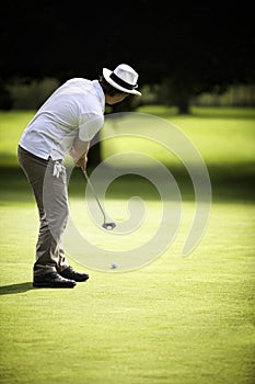 Male golfer putting