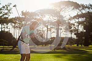 Male golfer taking shot