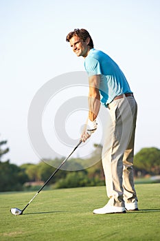 Male Golfer Teeing Off