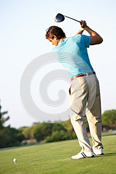 Male Golfer Teeing Off