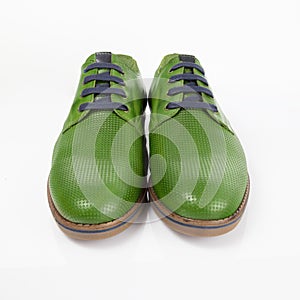Male green leather elegant shoes on white background.