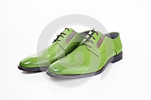 Male green leather elegant shoes on white background.