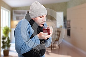 Male with grippe or influenza drinking tea