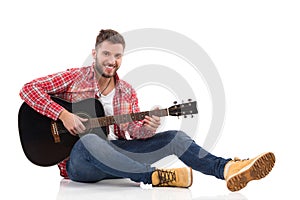 Male guitarist with acoustic guitar.