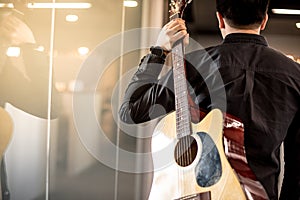 Male guitarist holding acoustic guitar