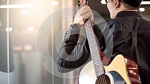 Male guitarist holding acoustic guitar