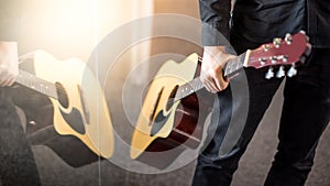 Male guitarist holding acoustic guitar