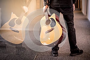 Male guitarist holding acoustic guitar