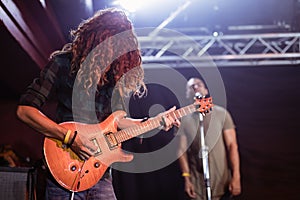 Male guitarist performing at nightclub