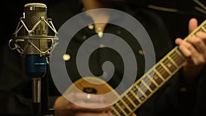 Male guitarist playing on acoustic guitar.