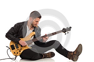 Male guitarist plays the bass guitar