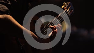 Male guitarist plays the guitar in the dark. Kyiv. Ukraine