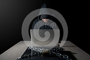 Male Hacker behind laptop computer, cyber attack concept