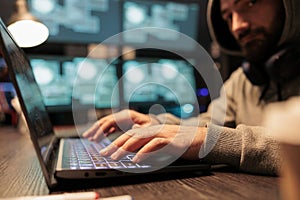 Male hacker using security breach to hack server