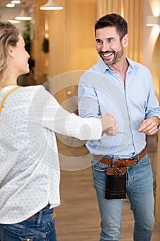 male hairdresser greeting female client