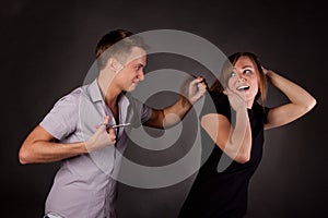 Male hairdresser maniac, mocks a woman photo