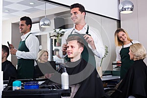 male hairstyler serving teenager