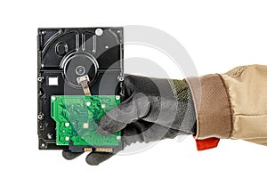 Male hand in black protective glove holding computer hard drive isolated on white background