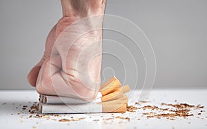 Male hand breaking a cigarettes. Quitting smoking