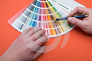 male hand choose color in palette samples