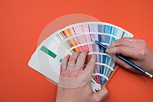 male hand choose color in palette samples