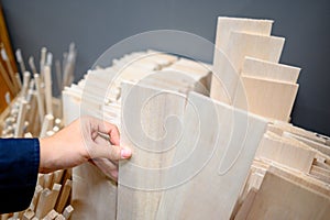 Male hand choosing balsa wood in stationery shop photo