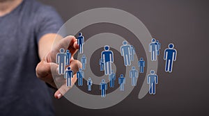 Male hand clicking on people icons- the concept of human resources management