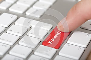 Male Hand Clicking red panic button on computer