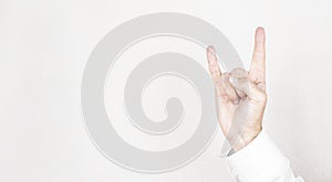 Male hand close-up on a white background shows hand gesture. Rock`n`roll. Isolate